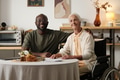 Portrait of Black Man Supporting Senior Caucasian Woman with Disability - PhotoDune Item for Sale