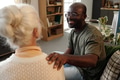 Young Black Man Comforting Senior Caucasian Woman Indoors - PhotoDune Item for Sale