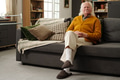 Portrait of Senior Caucasian Man Sitting on Sofa Smiling and Looking at Camera - PhotoDune Item for Sale