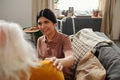 Young Adult Hispanic Woman Comforting Senior Caucasian Woman Indoors - PhotoDune Item for Sale