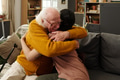 Senior Caucasian Man Embracing Young Adult Woman Indoors Showing Affection - PhotoDune Item for Sale