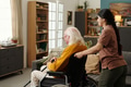 Young Adult Hispanic Woman Assisting Senior Caucasian Man with Disability - PhotoDune Item for Sale