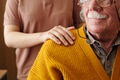 Senior Caucasian Man Receiving Gentle Support from Young Adult Woman Indoors - PhotoDune Item for Sale