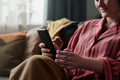 Young Adult Caucasian Woman with Prosthetic Hand Using Smartphone Indoors - PhotoDune Item for Sale