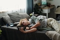 Teenage Caucasian Boy Lying on Bed Using Smartphone Suffering Gadget Addiction - PhotoDune Item for Sale