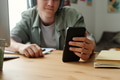 Teenage Caucasian Boy Using Smartphone While Ignoring Homework at Desk - PhotoDune Item for Sale