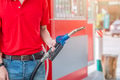 Closeup gas station staff worker hand holding fuel nozzle for refill car fuel, Petroleum business - PhotoDune Item for Sale