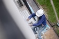 Exterior paint and leak repair technician builder, rope rappelling to repair buildings outside wall - PhotoDune Item for Sale