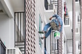 Exterior paint and leak repair technician builder, rope rappelling to repair buildings outside wall - PhotoDune Item for Sale