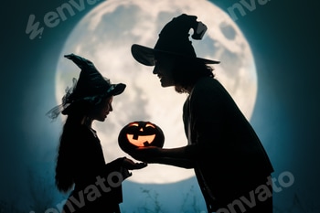 Woman and her daughter dressed in witch costumes