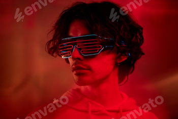 Portrait of Man with Wavy Hair Wearing Hoodie and Futuristic Neon Eyewear