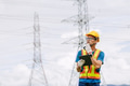 Professional engineer male with power line, Electrical distribution service team on duty outdoor - PhotoDune Item for Sale