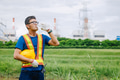 Engineer male Asian worker drinking clean water while working outdoor, Thirsty dry refreshing drink - PhotoDune Item for Sale