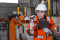 Technician engineer women test control operate inspection robot arm installation in factory. - PhotoDune Item for Sale
