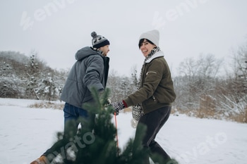 Couple celebrating winter holidays, buying christmas tree