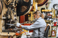 Professional master employee, senior high skill worker working punching in heavy metal industry - PhotoDune Item for Sale