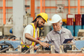 Professional African black worker working with senior chief technician in heavy industry factory - PhotoDune Item for Sale