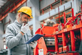 Professional senior Industrial worker in protective helmet and uniform service machinery in factory - PhotoDune Item for Sale