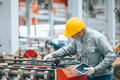 Professional senior Industrial worker in protective helmet and uniform service machinery in factory - PhotoDune Item for Sale