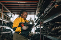 African black women engineer worker working in old used machine part stock warehouse. - PhotoDune Item for Sale