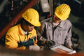 African women with engineer man staff worker working heavy industry old part warehouse - PhotoDune Item for Sale