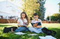 Students reading books sitting on school lawn - PhotoDune Item for Sale