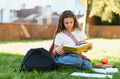 Young student girl studying on grass in park - PhotoDune Item for Sale