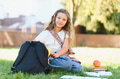 Schoolgirl studying on campus grass, back to school - PhotoDune Item for Sale