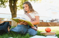 Student girl reading book on grass outdoors - PhotoDune Item for Sale
