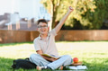 Happy student boy raising arm learning outdoors - PhotoDune Item for Sale