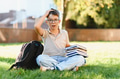 Young student feeling confused by homework on campus grass - PhotoDune Item for Sale