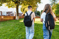 Students with backpacks walking to school on sunny day - PhotoDune Item for Sale