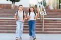 School children walking downstairs carrying backpacks and books - PhotoDune Item for Sale