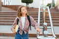 Young student girl walking school stairs holding books - PhotoDune Item for Sale