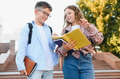 Schoolchildren discussing homework outdoors before classes - PhotoDune Item for Sale