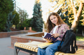 Schoolgirl studying outdoors on campus bench - PhotoDune Item for Sale