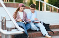 Schoolchildren studying together on campus stairs - PhotoDune Item for Sale
