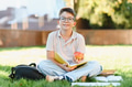 Young boy student sitting reading book outdoors - PhotoDune Item for Sale
