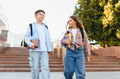 Students walking after school, talking and holding books - PhotoDune Item for Sale