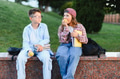Schoolchildren sitting on campus eating apples showing friendship - PhotoDune Item for Sale