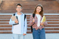 Schoolchildren standing outside campus with books and backpacks - PhotoDune Item for Sale