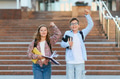 Happy schoolchildren celebrating success returning to school campus - PhotoDune Item for Sale