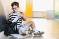 Schoolboy putting books in backpack at school corridor - PhotoDune Item for Sale