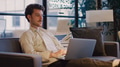Young Businessman Working On Laptop In Informal Seating Area Of Modern Office - PhotoDune Item for Sale