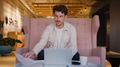 Young Businessman Working On Laptop In Informal Seating Area Of Modern Office - PhotoDune Item for Sale