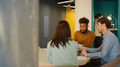 Young Multi Cultural Business Team Meeting Around Table In Seating Area Of Modern Office - PhotoDune Item for Sale