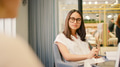 Two Young Businesswomen Meeting Around Table In Modern Office - PhotoDune Item for Sale