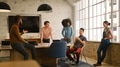 Young Multi Cultural Business Team Meeting Around Desk In Modern Office - PhotoDune Item for Sale