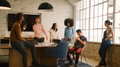 Young Multi Cultural Business Team Meeting Around Desk In Modern Office - PhotoDune Item for Sale