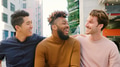 Portrait Of Three Young Smiling Male Friends Outdoors With City Buildings In Background - PhotoDune Item for Sale